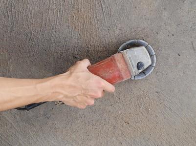 Grinding concrete with a concrete grinder
