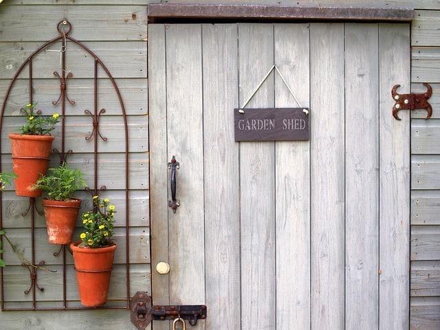 Garden shed with door and plants