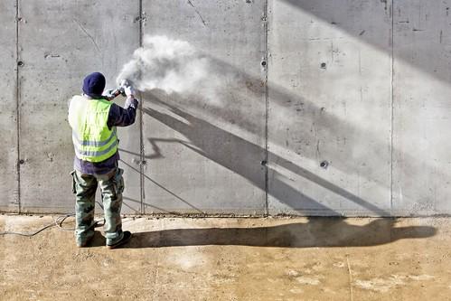 Sanding a concrete wall