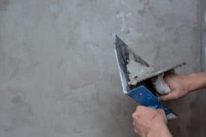 applying plaster on a wall